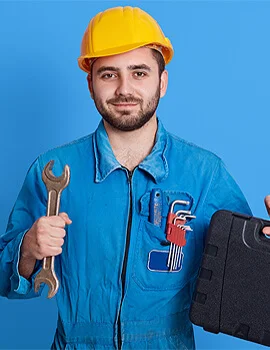 man in a hard head holding tools